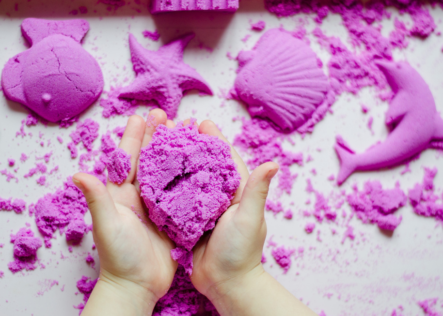 Girl preschooler sculpts kinesthetic sand at home. Developing activities for children. Art therapy. Psychological therapy for children.