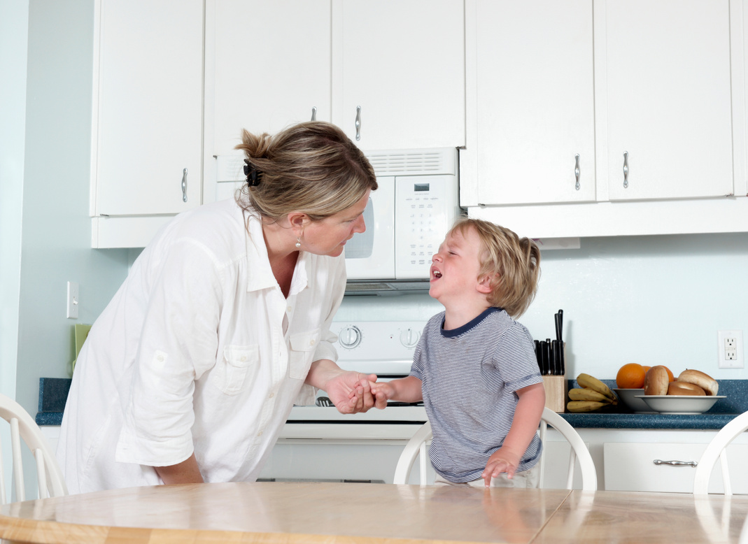 Mother trying to calm crying child at home